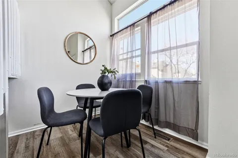 a view of a dining room with furniture and a window