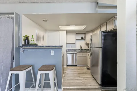 a kitchen with cabinets and stainless steel appliances