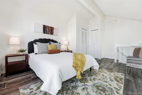 a bedroom with a bed and a lamp with rug