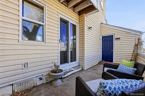 a view of a patio with two chairs and a potted plant
