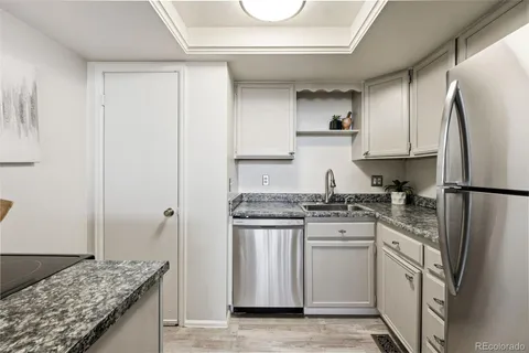 a kitchen with stainless steel appliances granite countertop a stove a refrigerator and a sink