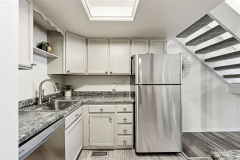 a kitchen with stainless steel appliances granite countertop a refrigerator sink and cabinets