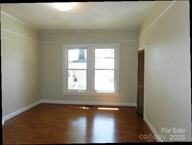 326 South Cedar Street Lincolnton, NC 28092 - Photo 11 of 16 an empty room with wooden floor and windows