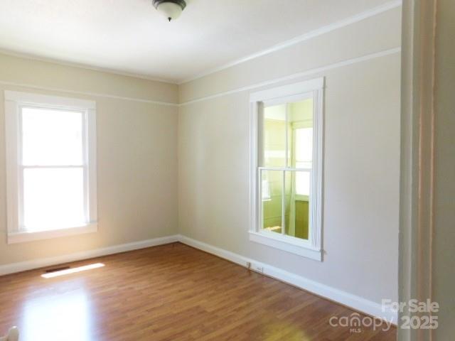 326 South Cedar Street Lincolnton, NC 28092 - Photo 3 of 16 a view of an empty room with wooden floor and a window