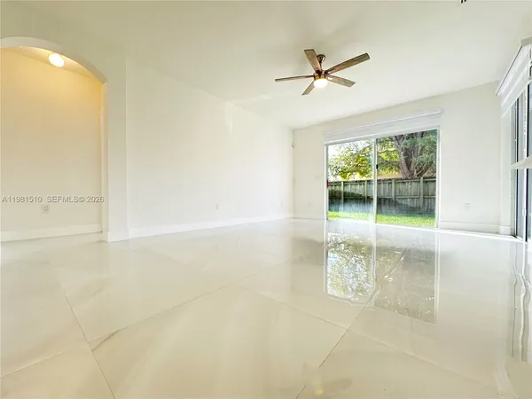 a view of a livingroom with a ceiling fan and window