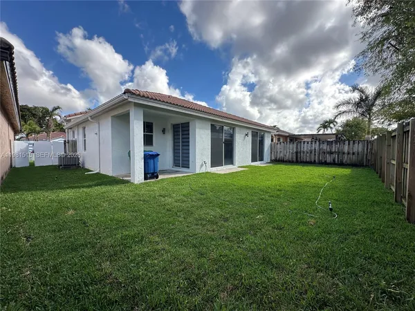 a view of a house with yard and a garden