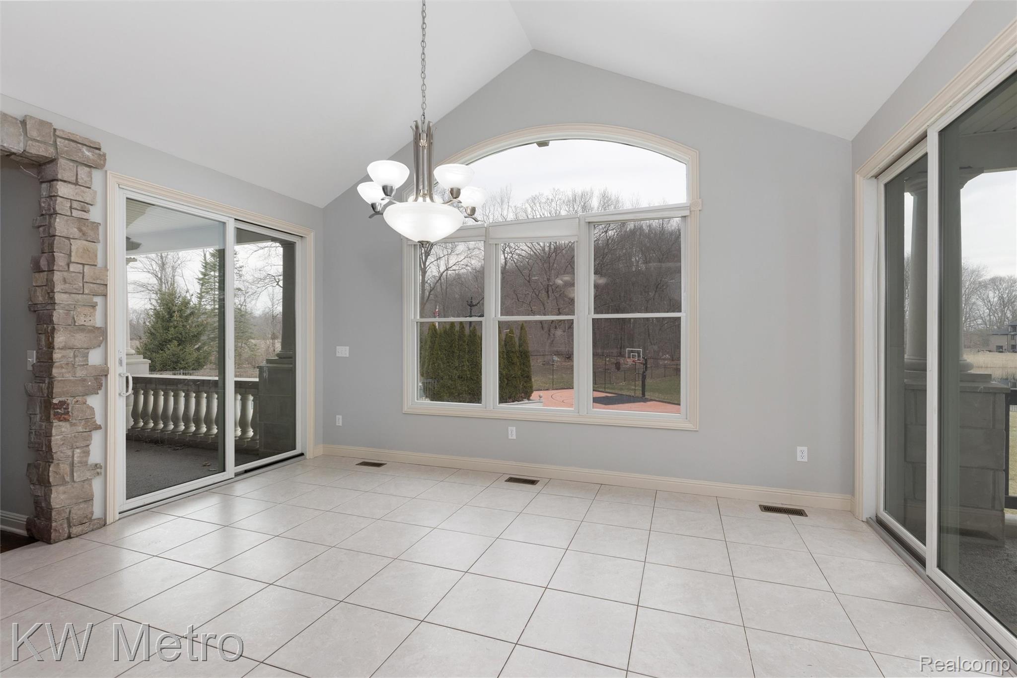 65884 Windrose Court Ray, MI 48096 - Photo 42 of 82 Unfurnished dining area with a chandelier and light tile patterned floors
