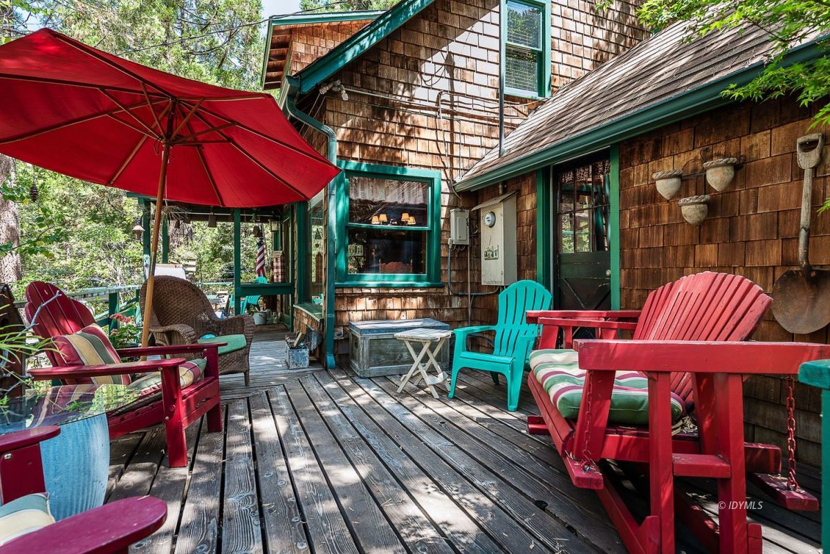 25440 Fern Valley Road Idyllwild, CA 92549 - Photo 10 of 32 an outdoor sitting area with red umbrella