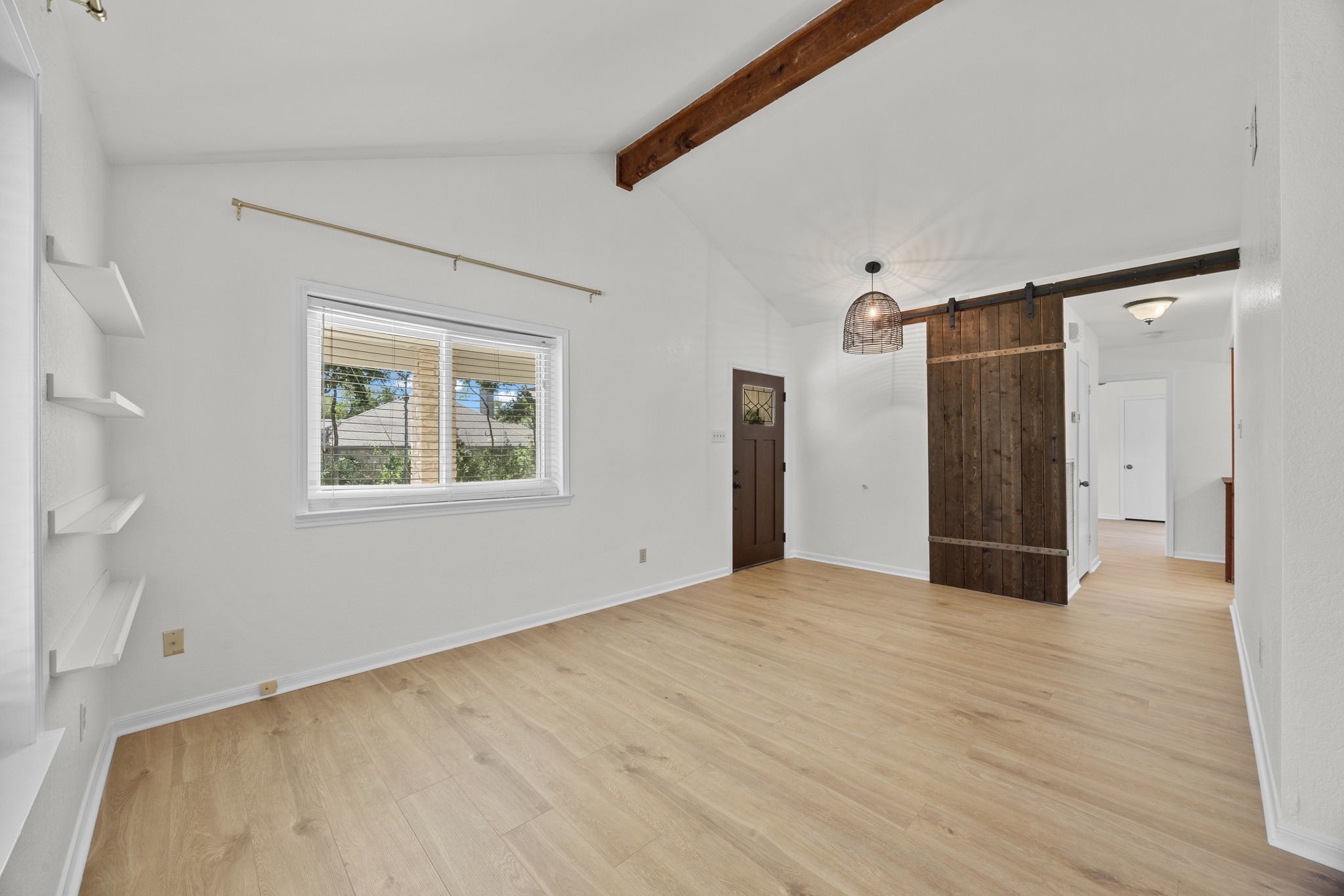 11019 Southwest Oaks Austin, TX 78737 - Photo 5 of 39 Set under a towering, beamed ceiling is the first living space.