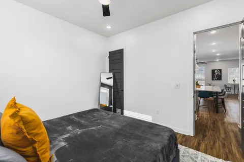 a bedroom with a bed and a chandelier