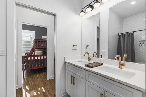 a bedroom with a bed and wooden floor