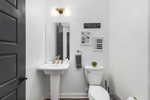 a bathroom with a sink mirror and a shower