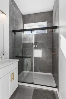 a kitchen with a sink a stove and chairs with wooden floor