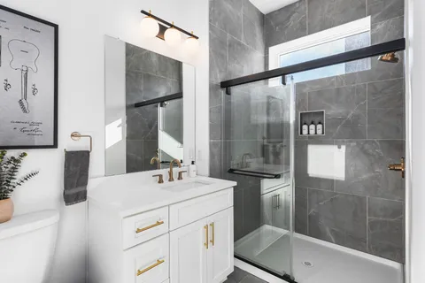 a view of a hallway with wooden floor and stairs