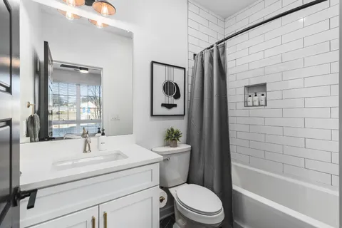 a view of a dining room with furniture a rug and wooden floor