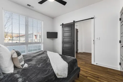 a kitchen with stainless steel appliances a dining table chairs microwave and refrigerator