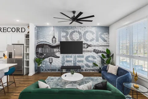 a living room with furniture and a wooden floor