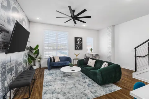 a living room with furniture and a dining table