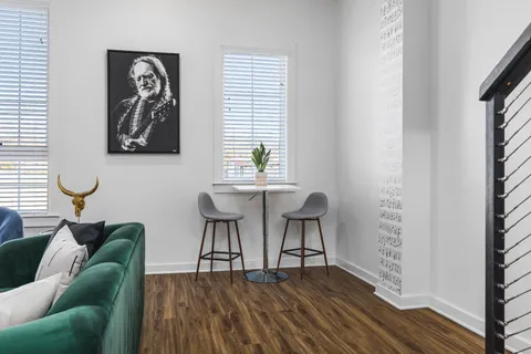 a living room with furniture and wooden floor