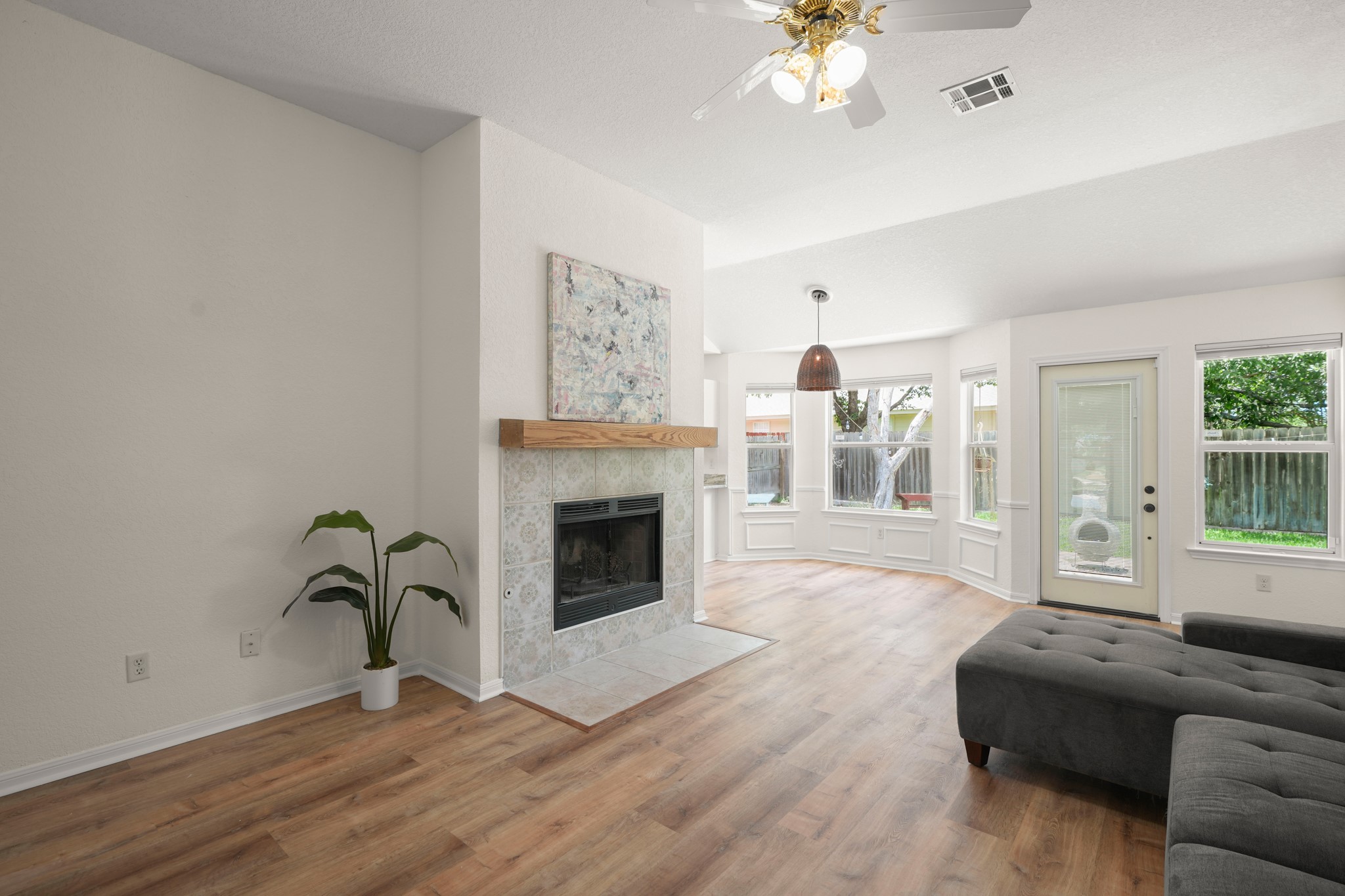 438 Katy Crossing Georgetown, TX 78626 - Photo 4 of 24 A comforting fireplace anchors this bright living space, complemented by a bay window and durable wood flooring.