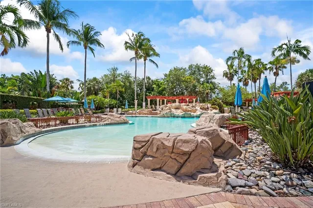 a view of swimming pool with outdoor seating and plants