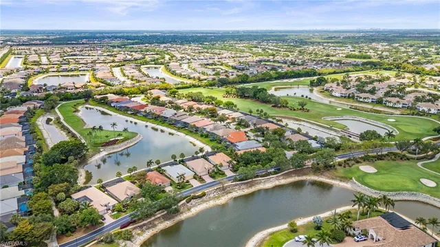 an aerial view of residential houses with outdoor space and swimming pool