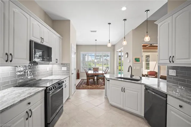 a kitchen with a sink stove and microwave