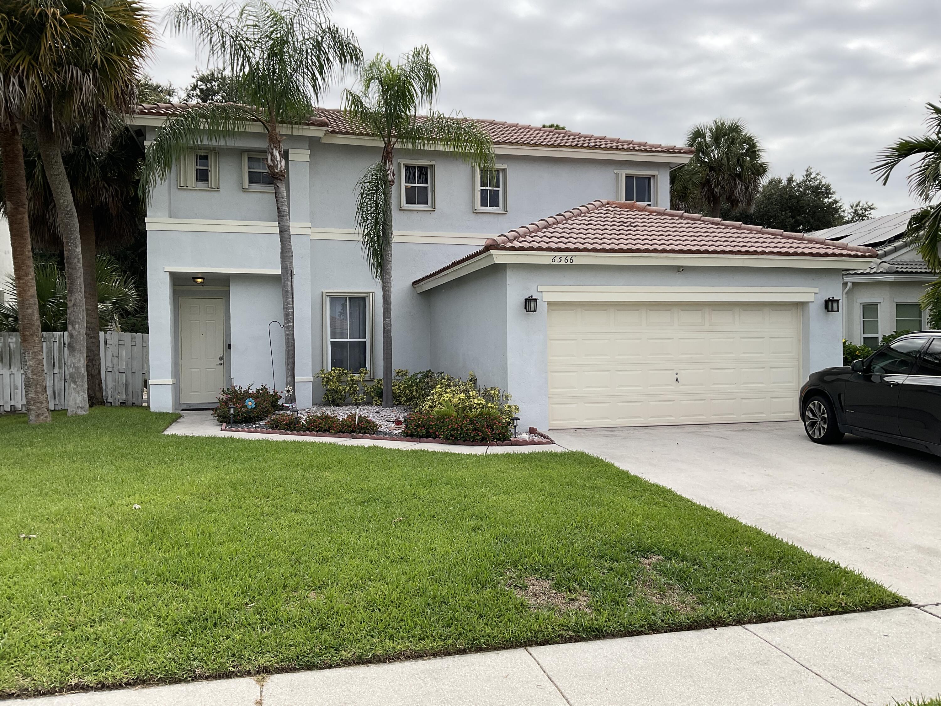 6566 Spring Meadow Drive Greenacres, FL 33413 - Photo 2 of 47 EXTERIOR FRONT