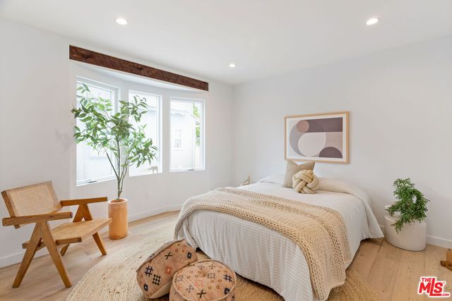 a bedroom with bed and a window