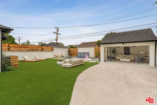 a view of a patio with furniture and a yard