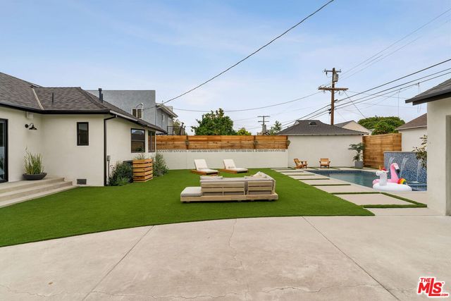 a view of a white house with a outdoor space