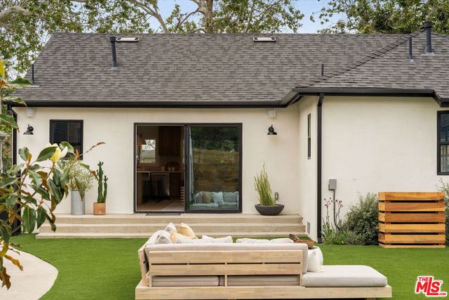 a front view of a house with a garden and plants