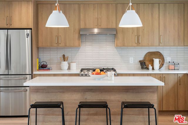 a kitchen with a sink a cabinets and appliances