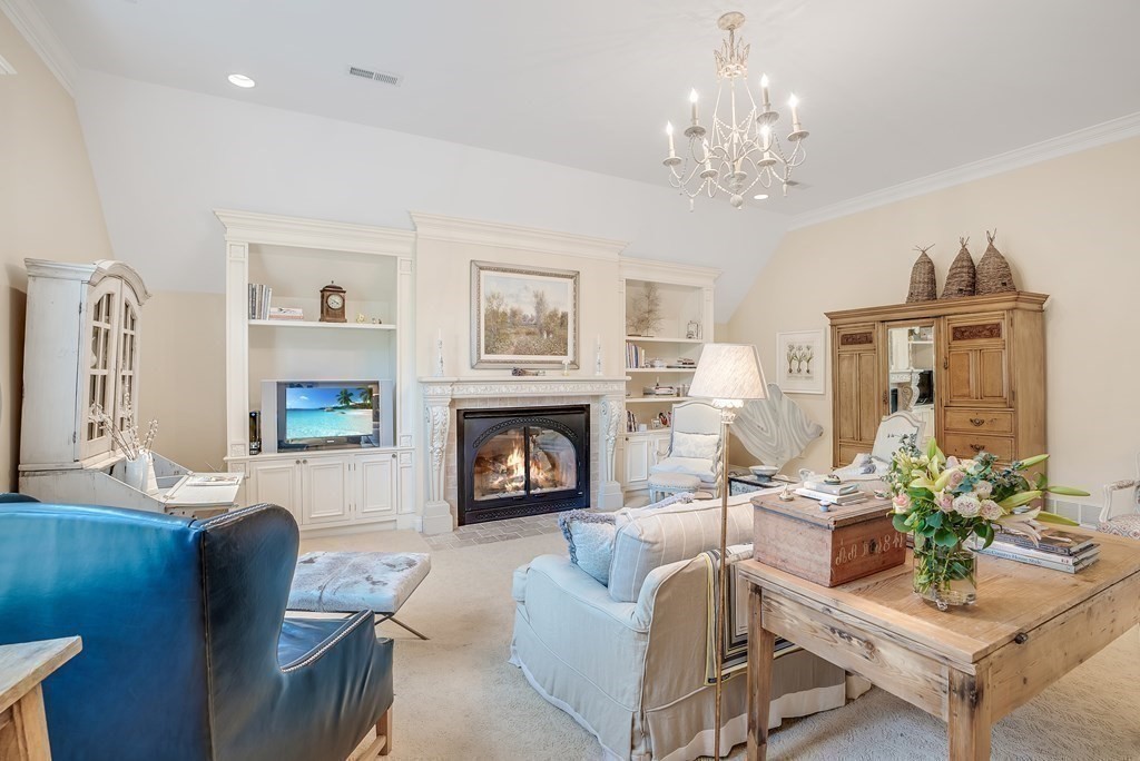 32 Bancroft Road Andover, MA 01810 - Photo 17 of 41 a living room with furniture a chandelier and a fireplace