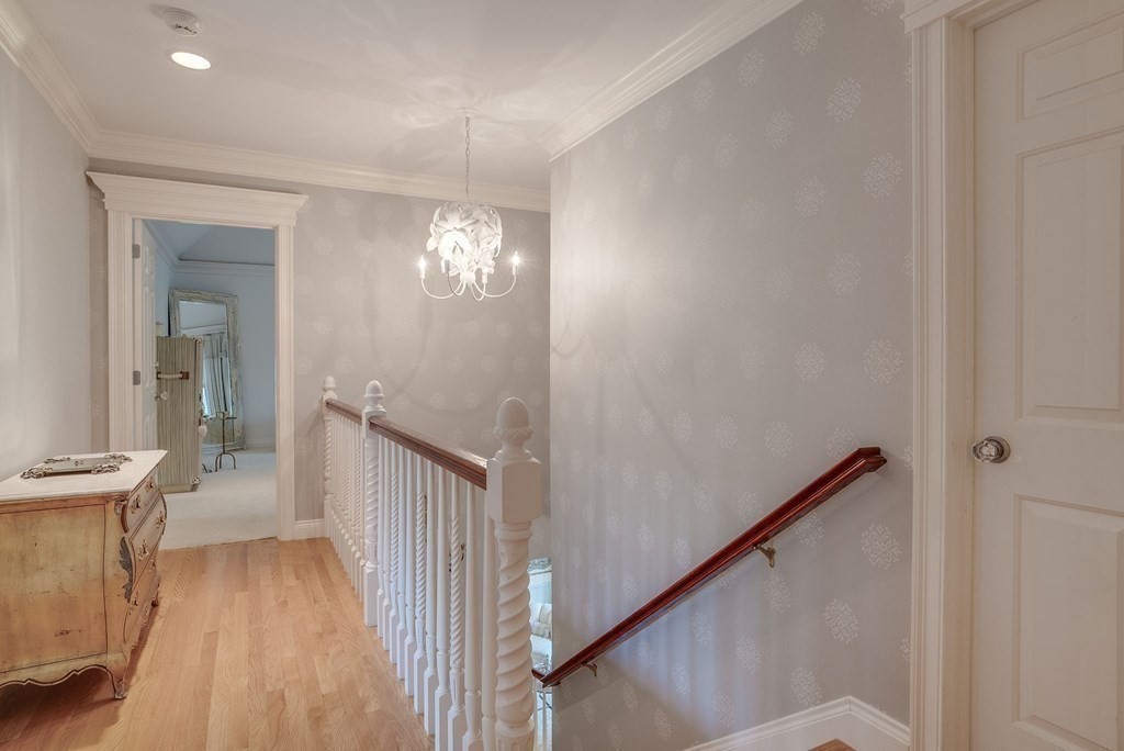 32 Bancroft Road Andover, MA 01810 - Photo 28 of 41 a view of a hallway with wooden floor and staircase