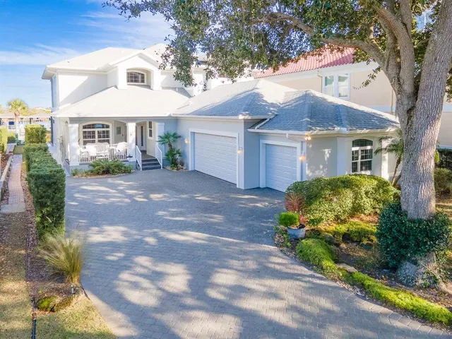 a front view of a house with a yard and a garden