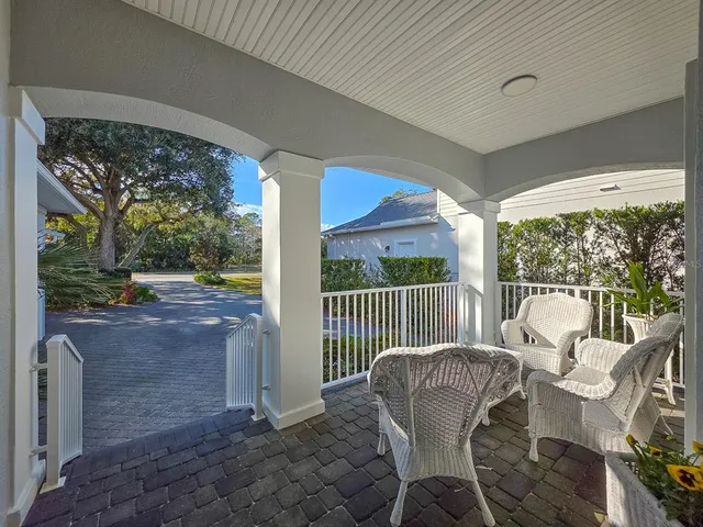 a view of a dining room with furniture a chandelier and wooden floor