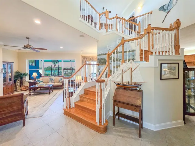 a view of a dining room with furniture large windows and wooden floor