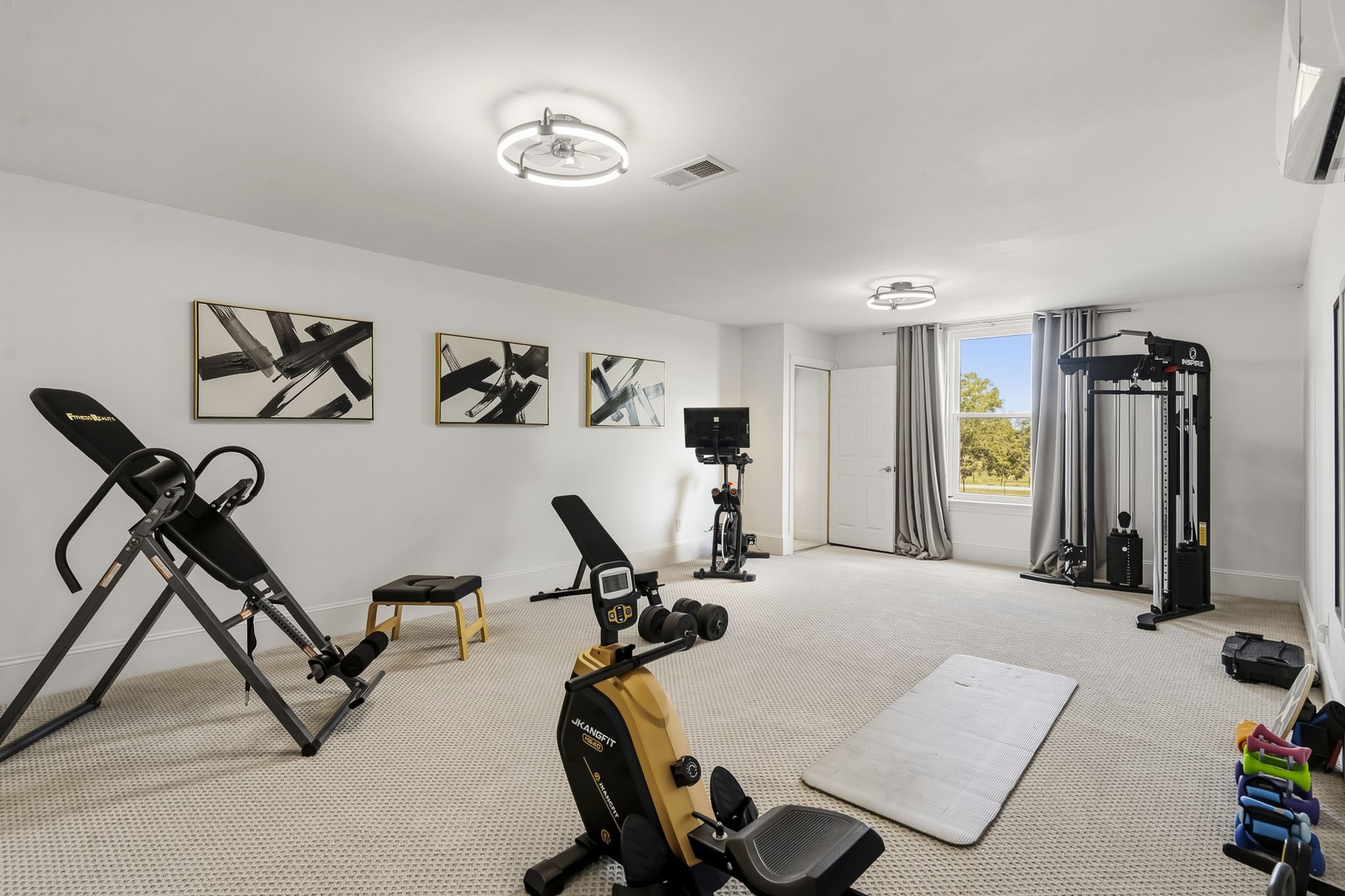 3103 Brundrett Road Wallis, TX 77485 - Photo 27 of 45 Tucked away upstairs, this expansive Media Room presents a world of possibilities. Currently utilized as a private fitness retreat, the space can effortlessly transform into a luxurious Home Theater, executive Office, entertainment Lounge, or recreation room. With its flexible design and generous proportions, this room offers the freedom to create a space perfectly tailored to your lifestyle.