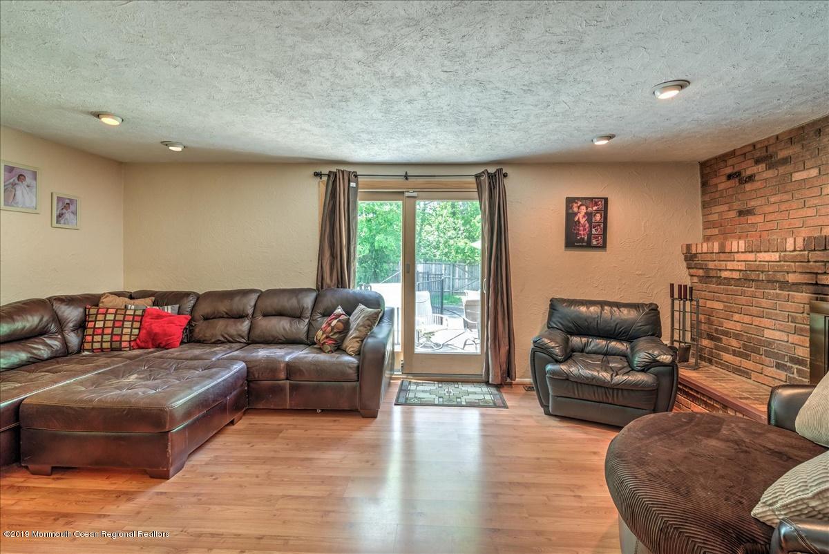 6 Timberline Drive Howell, NJ 07731 - Photo 4 of 12 a living room with furniture and a flat screen tv
