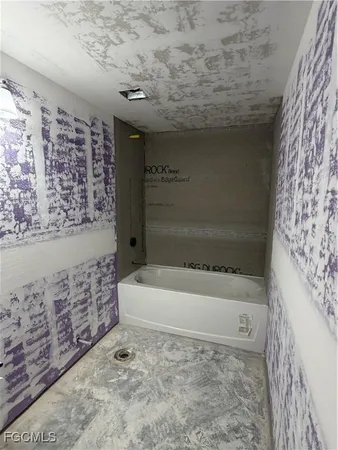 a bathroom with a bathtub and shower
