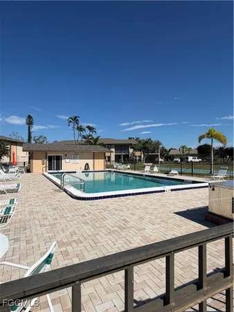 a view of a swimming pool with an outdoor seating