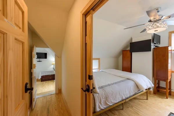 a bedroom with a bed and a chandelier