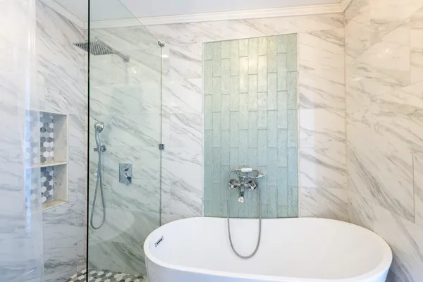 a bathroom with a bathtub and shower