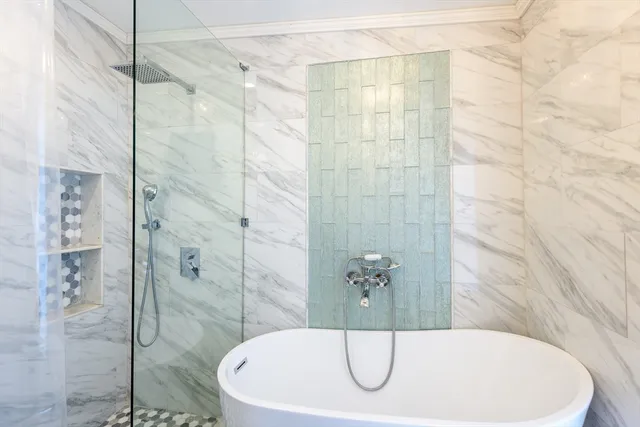 a bathroom with a bathtub and shower