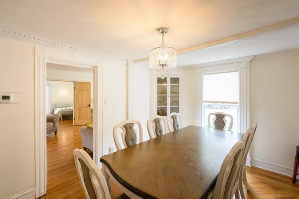 a view of a dining room with furniture window and wooden floor