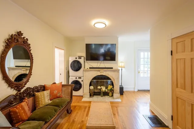 a living room with furniture a fireplace and a flat screen tv