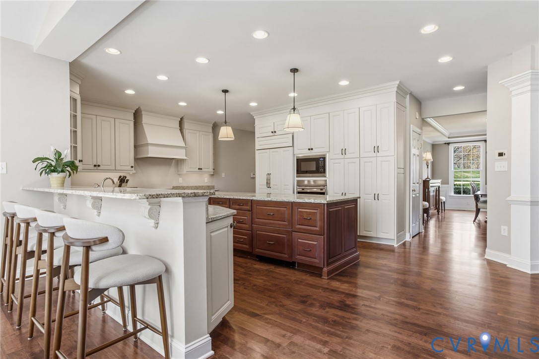 3100 Sodbury Court Midlothian, VA 23113 - Photo 23 of 94 a large kitchen with kitchen island granite countertop lots of white cabinets appliances and furniture