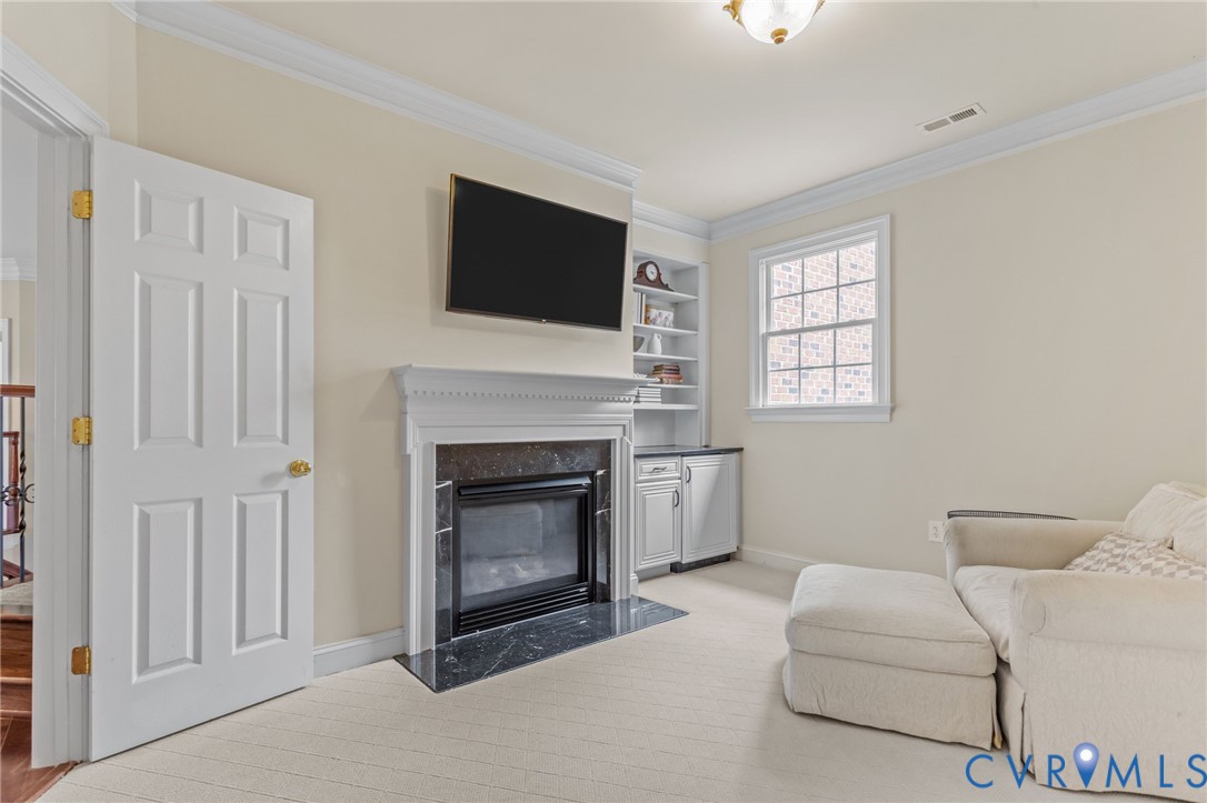 3100 Sodbury Court Midlothian, VA 23113 - Photo 34 of 94 a living room with furniture a flat screen tv and a fireplace