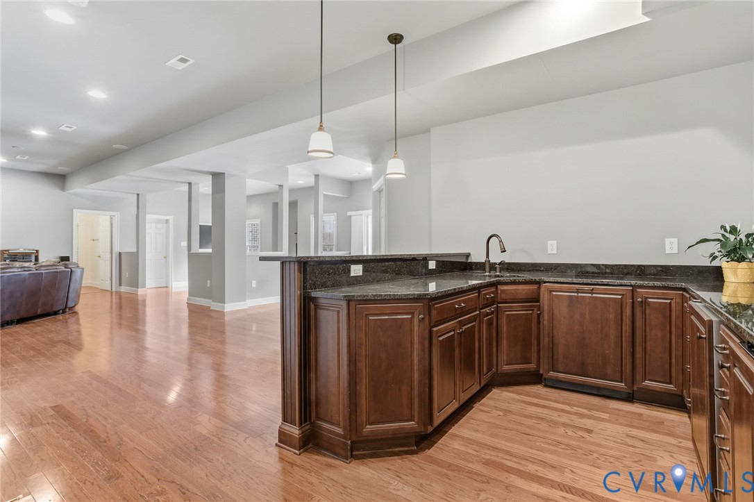 3100 Sodbury Court Midlothian, VA 23113 - Photo 58 of 94 a kitchen with stainless steel appliances granite countertop a sink a stove and a wooden floors
